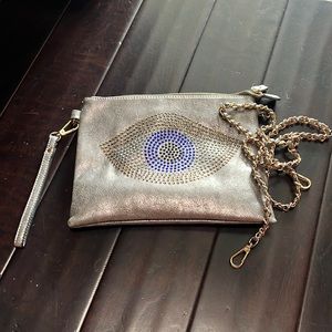 Clutch with Crystal eye. Can be a wristlet, shoulder bag or crossbody.